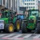 Article: Are conspiracy groups trying to hijack farmers’ protests? Image description: Tractors parked and road traffic at a standstill in the European Quarter in Brussels.