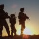 Troops standing in a sunset