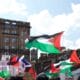Article headline: Arms lobby group urged UK and Scottish Governments to crack down on Palestine Action Image description: Protesters wave Palestinian flags and hold placards during a pro-Palestine demonstration in Glasgow city centre, with historic buildings in the background.