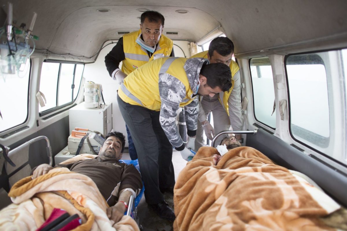 Kurdish medics and injured Mosul residents in ambulance