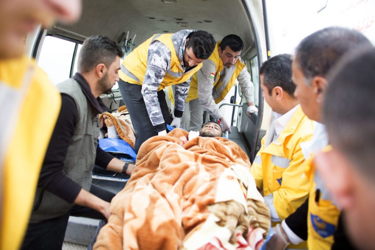 Kurdish medics and injured Mosul residents in ambulance