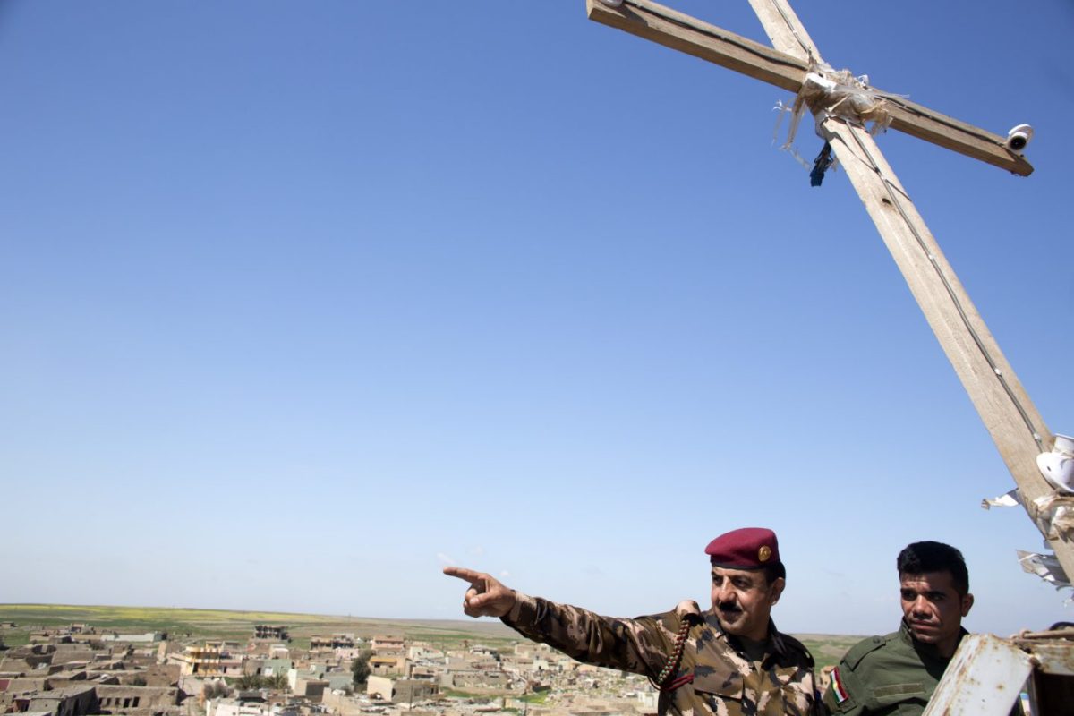 The Peshmerga’s Major Jaffer points to a cemetery about half a mile away