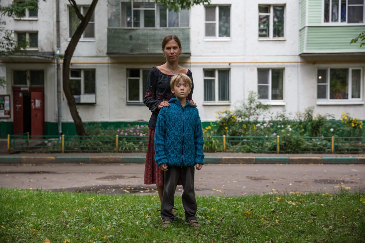 Yulia Fedosova and her son Maxim outside their family home, which is scheduled for demolition.