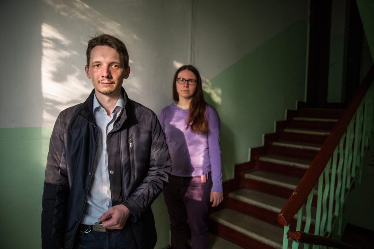 Nikolai Kanchov, who stood in recent municipal elections for the opposition party Yabloko, and resident Anastasia inside one of the condemned flats in the Metrogorodsky District.