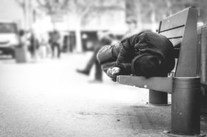Person sleeping on bench