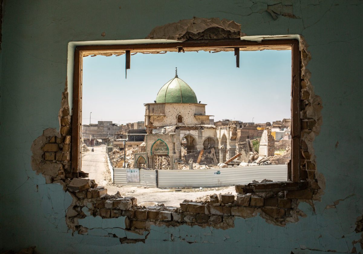 The Mosque of al-Nuri seen through a damaged window - West Mosul