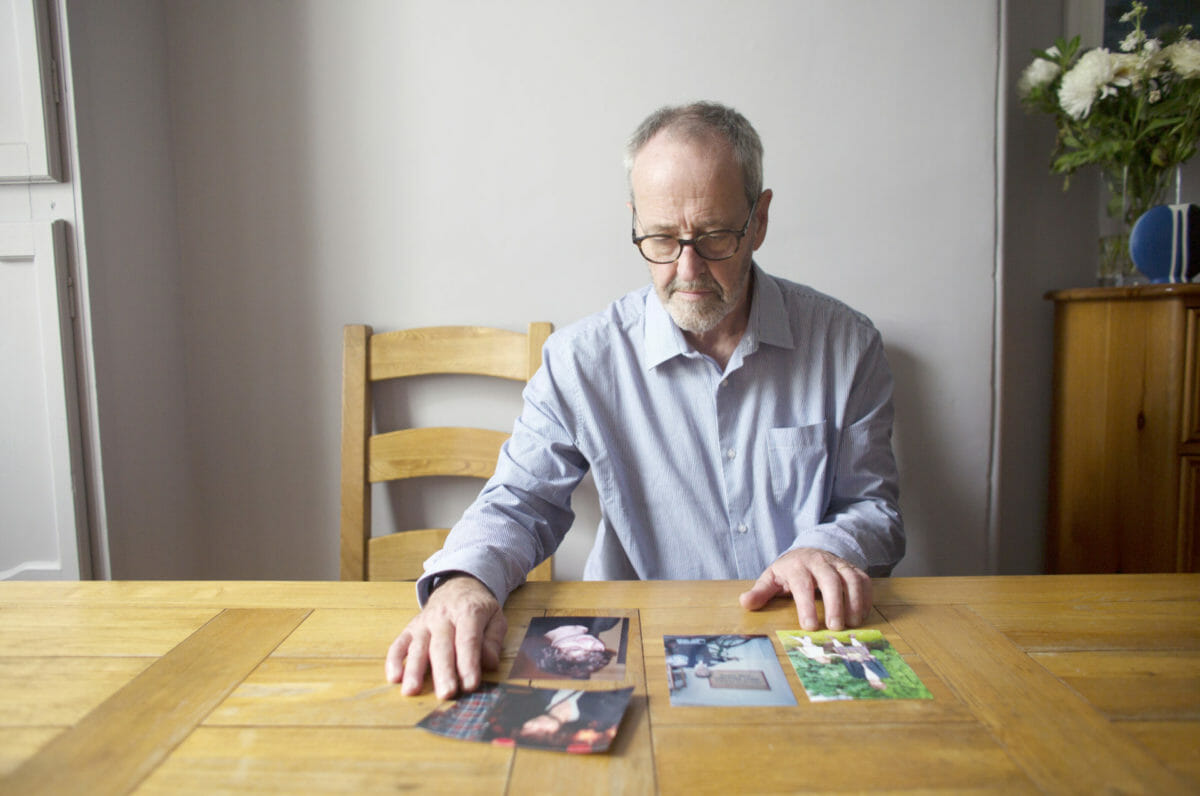 Fred looking at photos of his son.