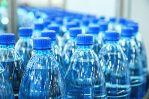 Closeup of plastic bottles on production line.