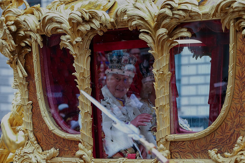 King Charles in a ceremonial carriage at his coronation