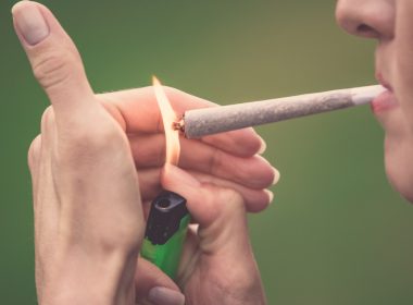 Woman lighting a cannabis joint