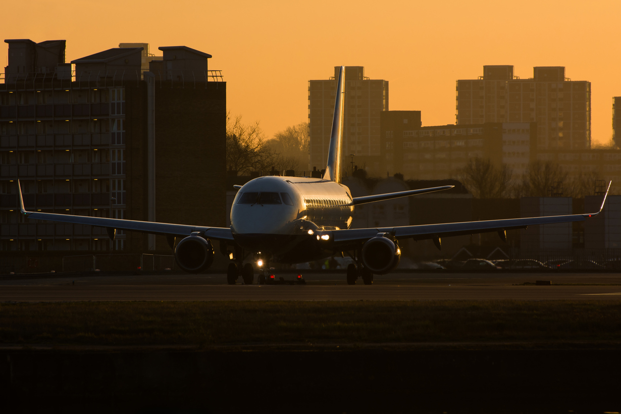 Plane taking off in twilight.