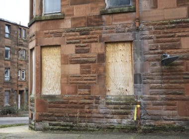 Empty tenement flat with boarded up windows